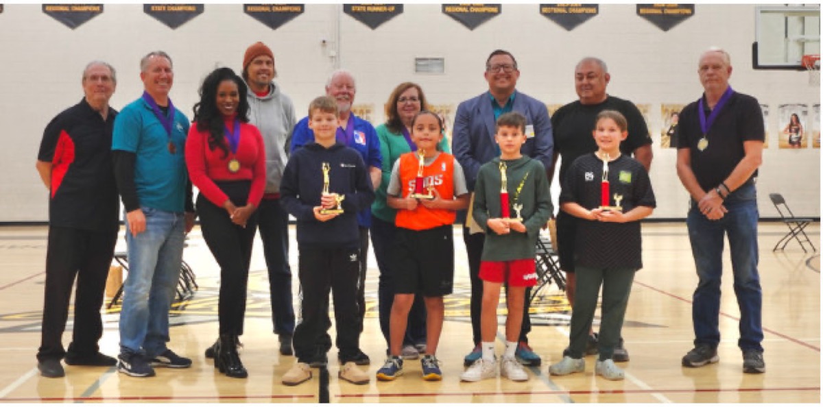 Hoop Shoot winners in the 10 to 11 year old divisions holding trophies with Elks volunteers