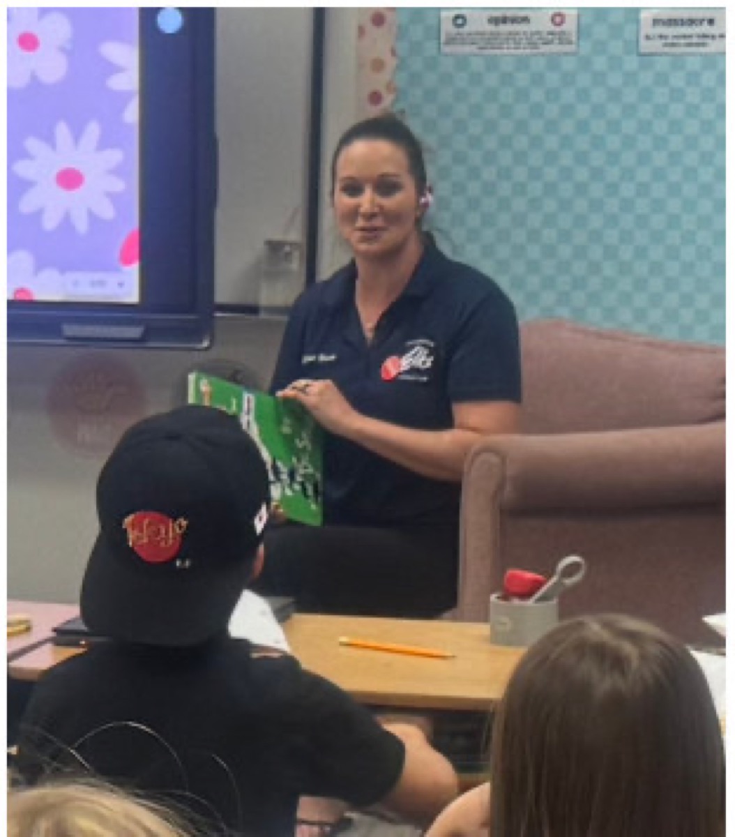 Stephanie Beasley reading a story aloud to the class
